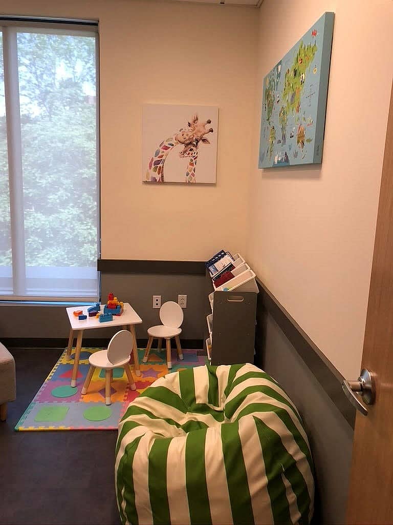 A room renovation with a bean bag chair, children's table and chairs and wall artwork