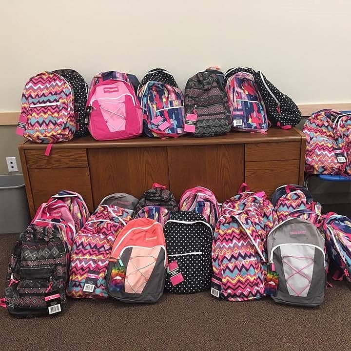 Photo of many backpacks in a pile.