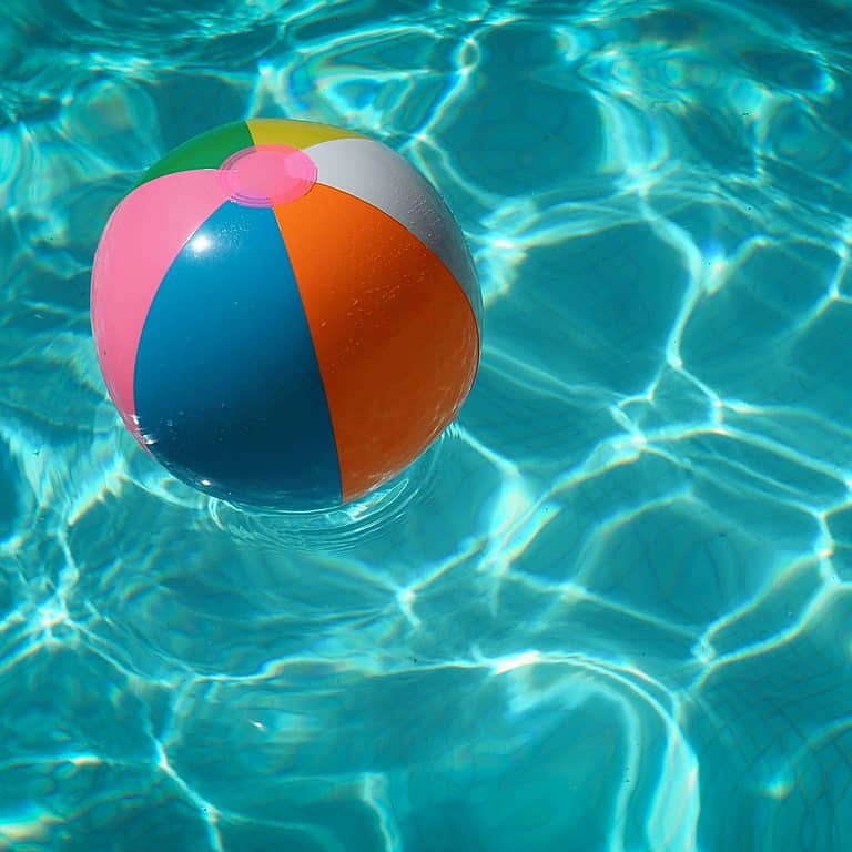 Image of a beach ball floating in a pool.